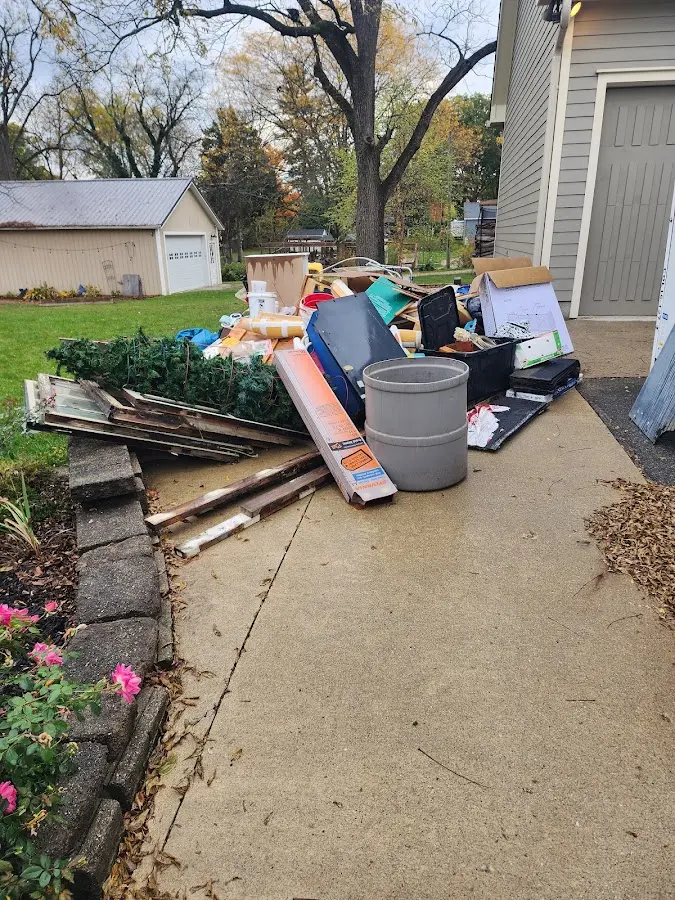 Dumpster being loaded with debris for Estate Cleanout Dumpster Rental in Airmont